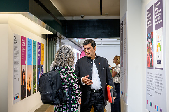 Professor Shitij visits the One King’s Impact exhibition and reads all information about the funded projects. He is being guided by Melanie Abas.
